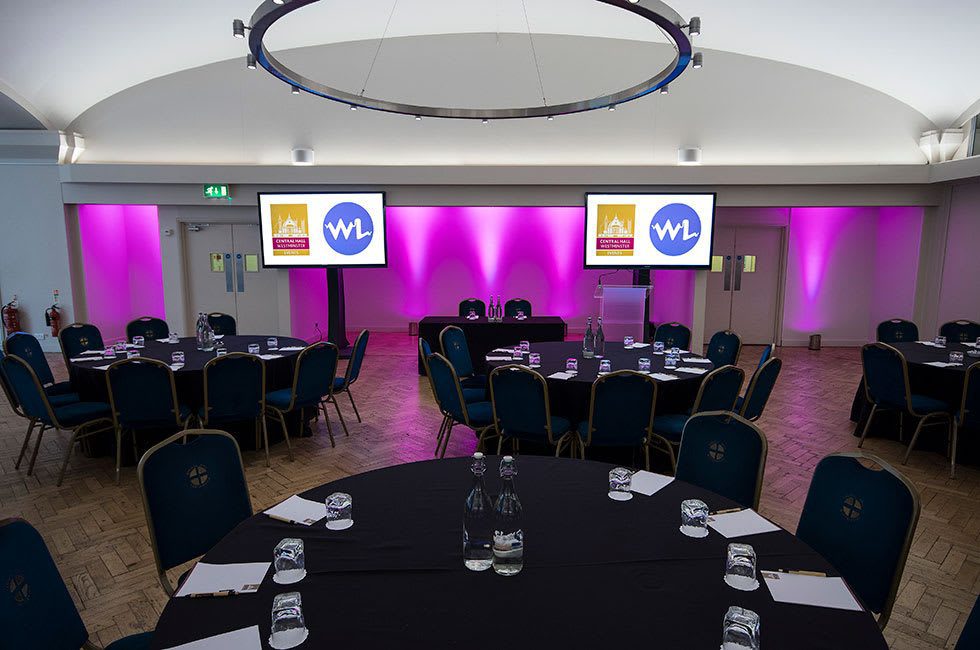 The Aldergate room in cabaret set-up and pink uplighters