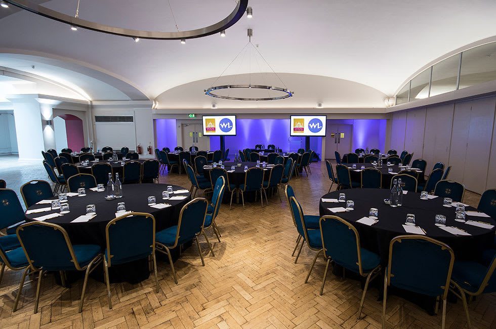 Aldergate room in cabaret set-up with purple uplighters